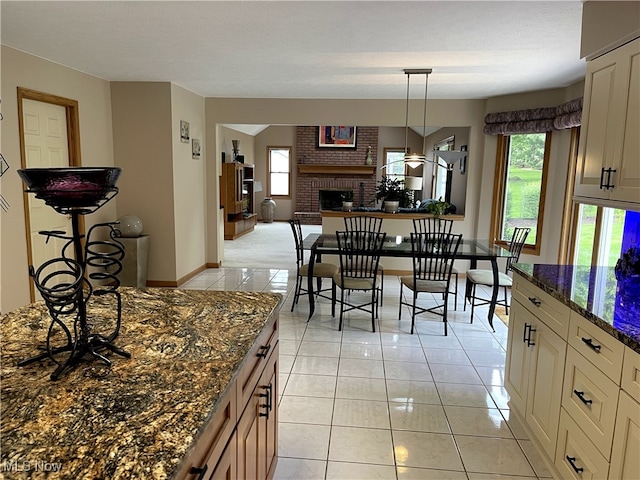12701 Gordon St, North Royalton, OH 44133 - dining room featuring a brick fireplace and light tile patterned floors