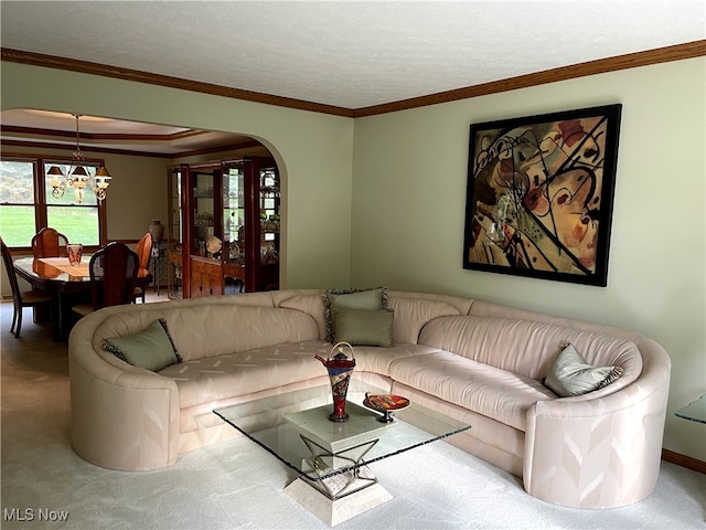 12701 Gordon St, North Royalton, OH 44133 - living room with carpet flooring, a chandelier, arched walkways, ornamental molding, and a textured ceiling