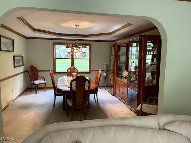 12701 Gordon St, North Royalton, OH 44133 - dining room with a raised ceiling, arched walkways, crown molding, and light carpet