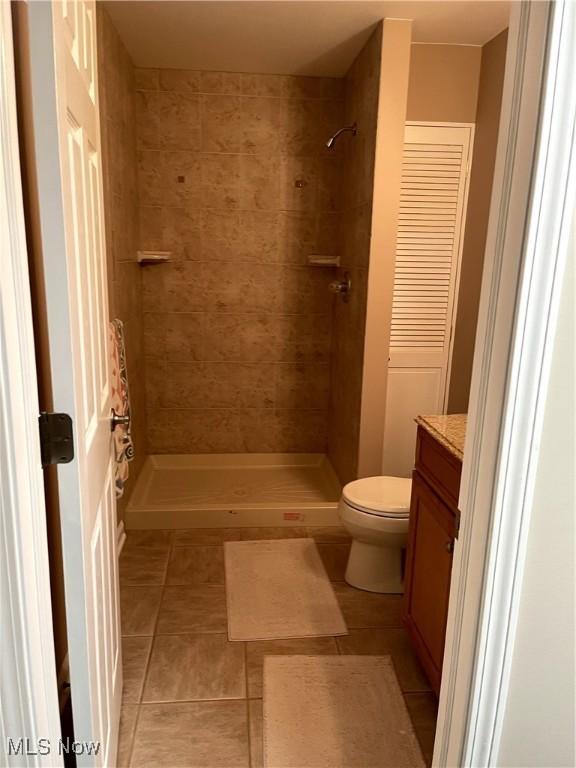 12701 Gordon St, North Royalton, OH 44133 - bathroom featuring vanity, tile patterned floors, and a tile shower