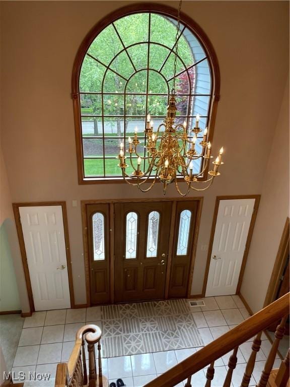 12701 Gordon St, North Royalton, OH 44133 - entrance foyer featuring a towering ceiling, light tile patterned floors, and a chandelier