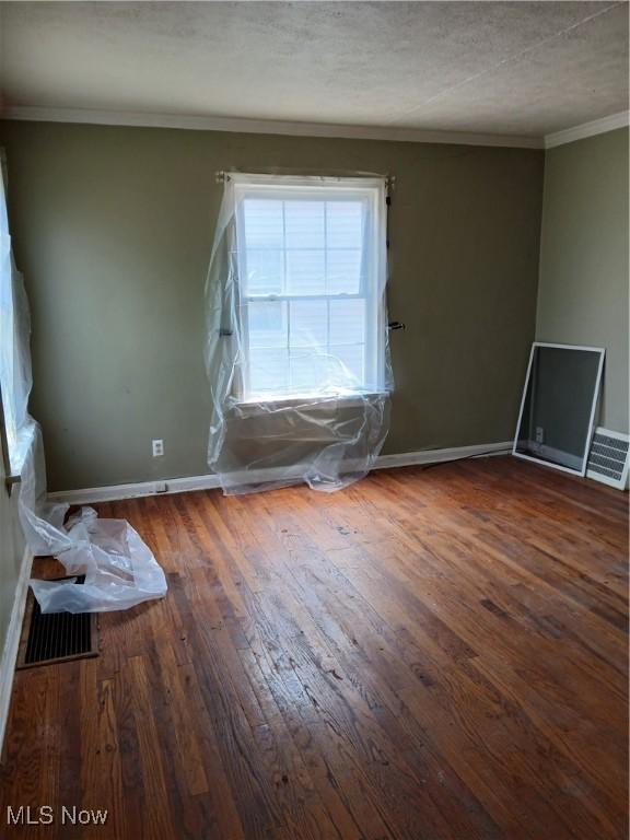 230 E 211th St, Euclid, OH 44123 - spare room featuring baseboards, hardwood / wood-style floors, and crown molding