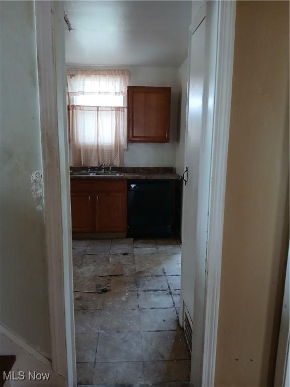 230 E 211th St, Euclid, OH 44123 - kitchen with black dishwasher, a sink, dark countertops, and brown cabinets