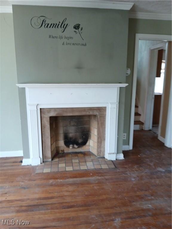 230 E 211th St, Euclid, OH 44123 - detailed view of a fireplace with flush hearth, crown molding, wood finished floors, and baseboards