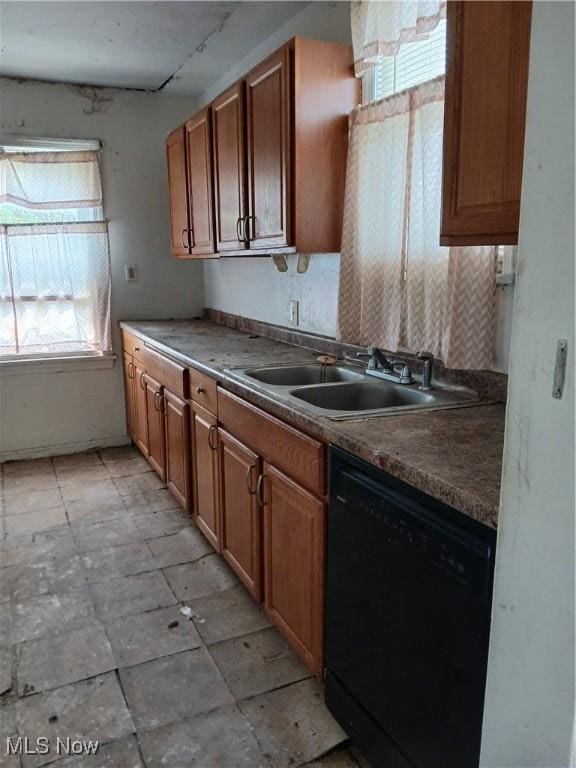 230 E 211th St, Euclid, OH 44123 - kitchen with dishwasher, a sink, rail lighting, and brown cabinetry