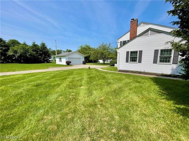 180 Atterbury Blvd, Hudson, OH 44236 - view of side of home with a chimney, a detached garage, a lawn, and an outdoor structure