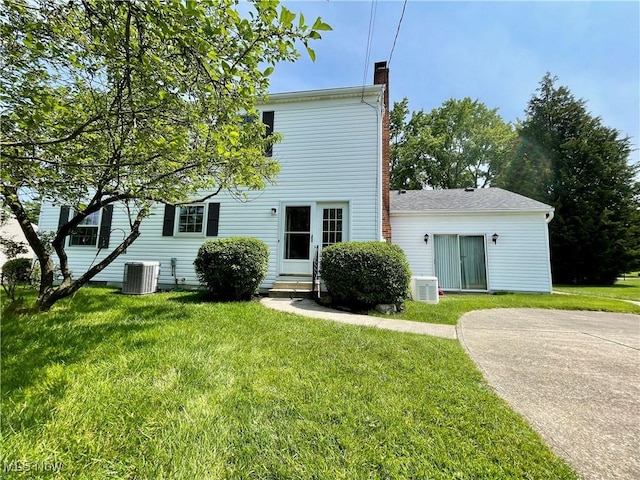 180 Atterbury Blvd, Hudson, OH 44236 - back of house with a chimney, entry steps, central AC, and a lawn