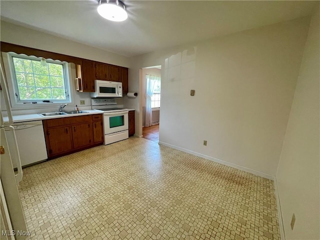 180 Atterbury Blvd, Hudson, OH 44236 - kitchen with white appliances, a sink, light countertops, baseboards, and light flooring