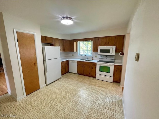 180 Atterbury Blvd, Hudson, OH 44236 - kitchen featuring white appliances, a sink, light countertops, brown cabinetry, and baseboards