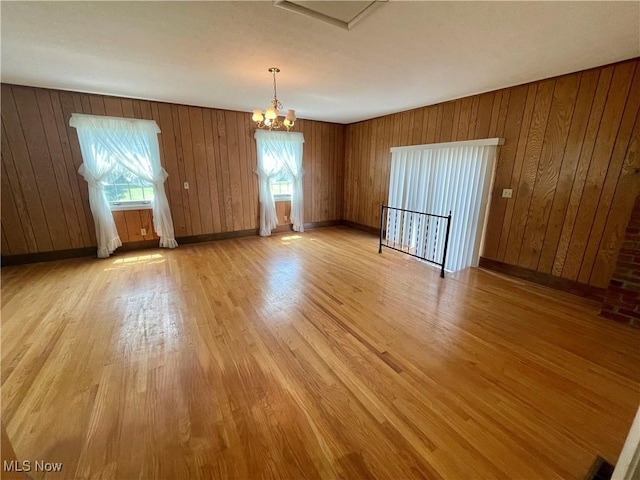 180 Atterbury Blvd, Hudson, OH 44236 - empty room featuring plenty of natural light, a chandelier, light wood-style floors, and wooden walls