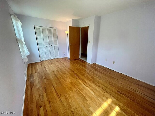 180 Atterbury Blvd, Hudson, OH 44236 - unfurnished bedroom with light wood-style flooring, a closet, and baseboards