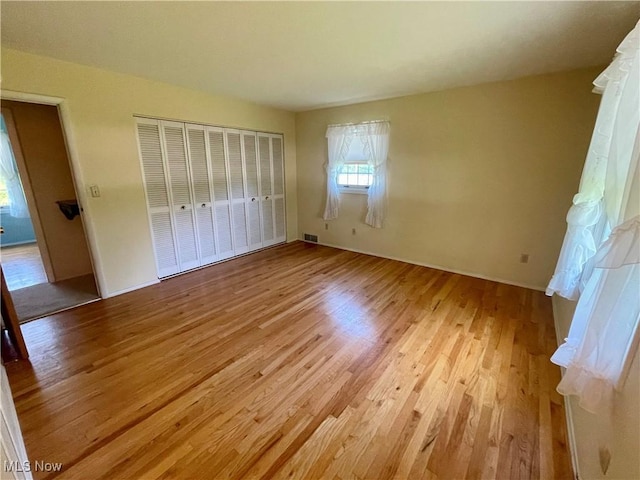180 Atterbury Blvd, Hudson, OH 44236 - unfurnished bedroom featuring light wood-style flooring, a closet, and baseboards