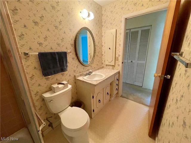 180 Atterbury Blvd, Hudson, OH 44236 - bathroom with vanity, wallpapered walls, toilet, a closet, and tiled shower