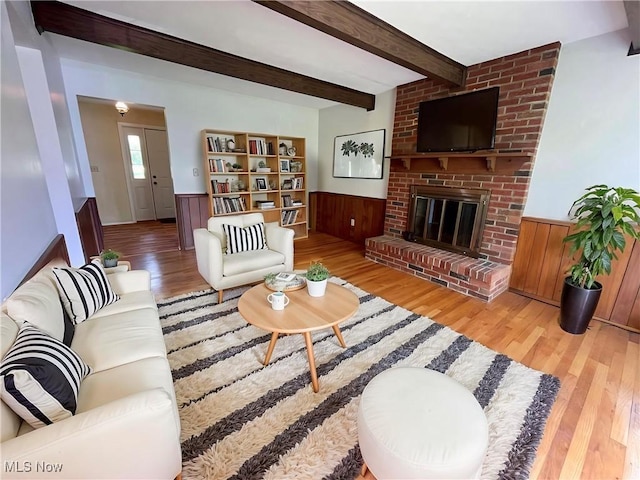 180 Atterbury Blvd, Hudson, OH 44236 - living area featuring a wainscoted wall, wood finished floors, beam ceiling, a fireplace, and wood walls
