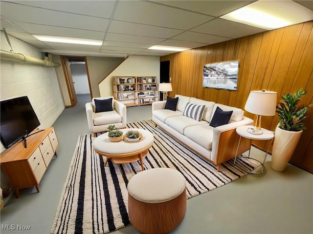 180 Atterbury Blvd, Hudson, OH 44236 - living room with a drop ceiling, wood walls, and finished concrete flooring