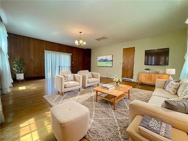 180 Atterbury Blvd, Hudson, OH 44236 - living area featuring a chandelier, light wood-style floors, wooden walls, and baseboards