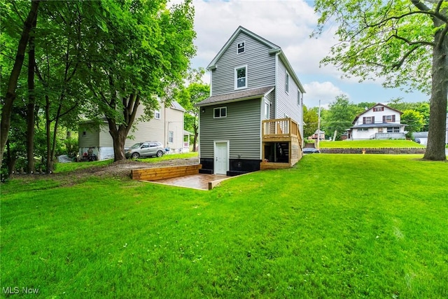 90 Frank St, Struthers, OH 44471 - rear view of property with a lawn and a wooden deck