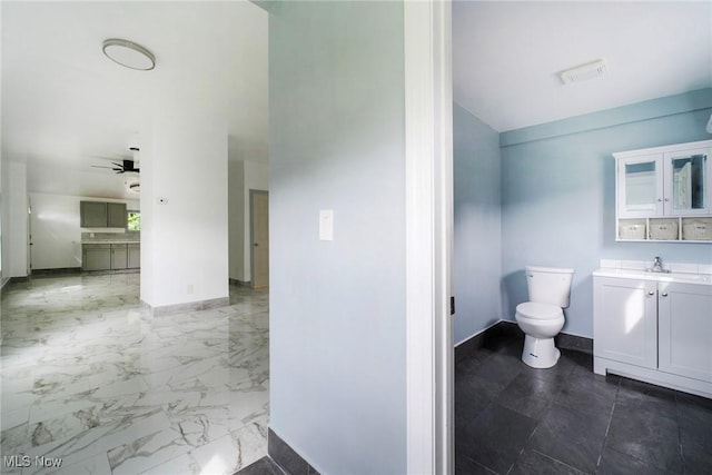 90 Frank St, Struthers, OH 44471 - bathroom with baseboards, vanity, toilet, a ceiling fan, and lofted ceiling