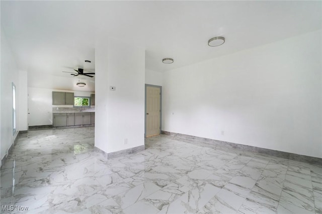 90 Frank St, Struthers, OH 44471 - unfurnished living room with baseboards, a ceiling fan, and marble finish floors