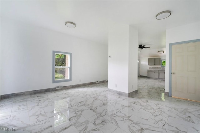 90 Frank St, Struthers, OH 44471 - unfurnished living room featuring baseboards, marble finish flooring, and a ceiling fan