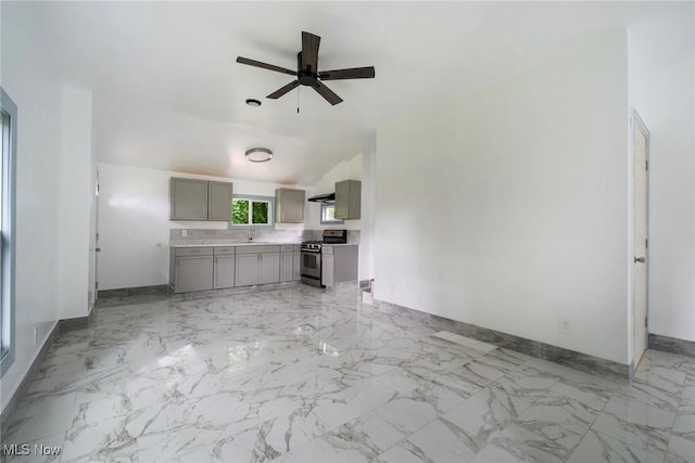 90 Frank St, Struthers, OH 44471 - unfurnished living room featuring ceiling fan, baseboards, a sink, light marble finish floors, and vaulted ceiling
