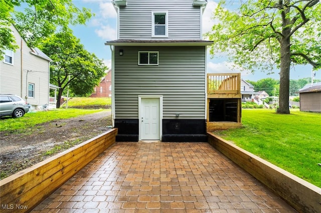 90 Frank St, Struthers, OH 44471 - back of property with a lawn, a deck, and a patio