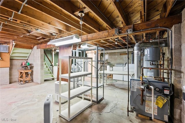 12873 Unity Rd, New Springfield, OH 44443 - unfinished below grade area with washer and dryer, a heating unit, stairs, and concrete block wall