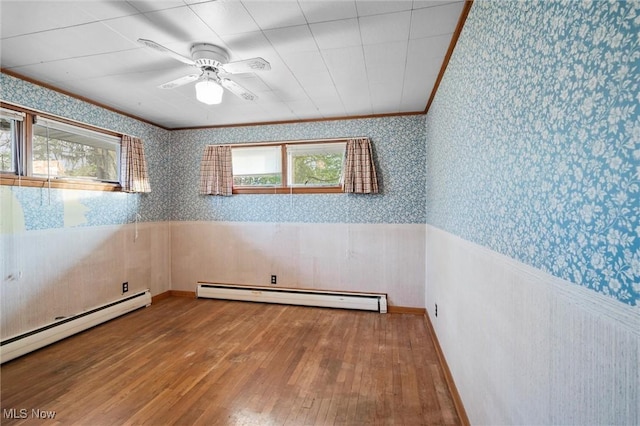 12873 Unity Rd, New Springfield, OH 44443 - spare room featuring wallpapered walls, a baseboard radiator, hardwood / wood-style flooring, wainscoting, and ornamental molding