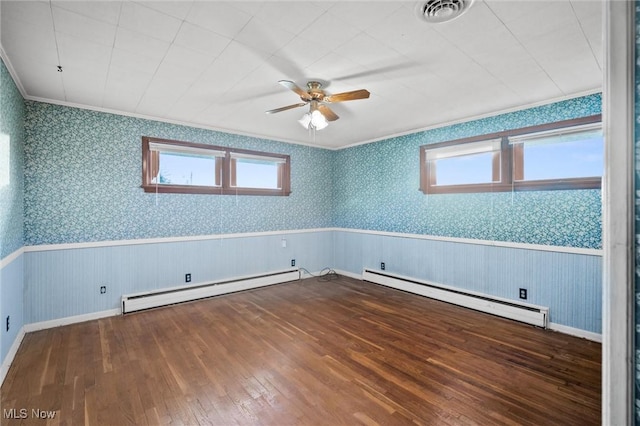 12873 Unity Rd, New Springfield, OH 44443 - unfurnished room featuring a baseboard heating unit, baseboard heating, plenty of natural light, a wainscoted wall, and hardwood / wood-style flooring