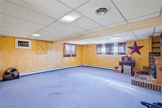 12873 Unity Rd, New Springfield, OH 44443 - basement featuring wooden walls, carpet, an AC wall unit, a paneled ceiling, and a baseboard heating unit