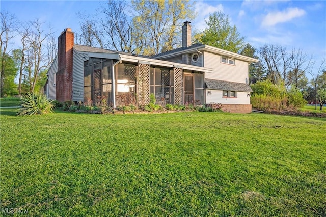 12873 Unity Rd, New Springfield, OH 44443 - rear view of house featuring a sunroom, a chimney, and a lawn