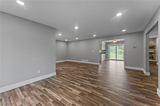 3371 Padanarum Rd, Geneva, OH 44041 - unfurnished living room with dark wood finished floors, baseboards, and recessed lighting