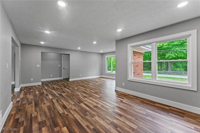 3371 Padanarum Rd, Geneva, OH 44041 - empty room with dark wood-style floors, recessed lighting, and baseboards