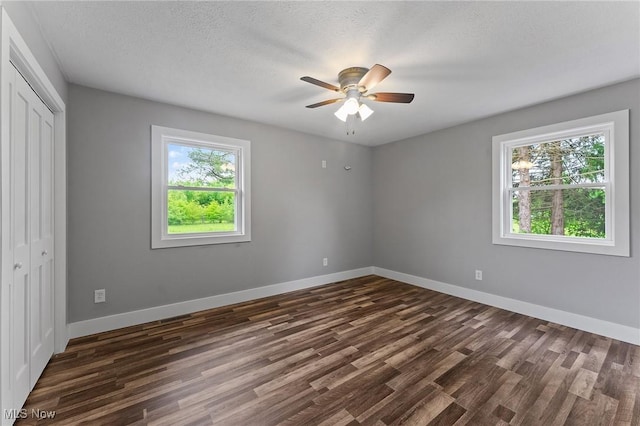3371 Padanarum Rd, Geneva, OH 44041 - unfurnished bedroom with dark wood finished floors, a closet, baseboards, and a textured ceiling