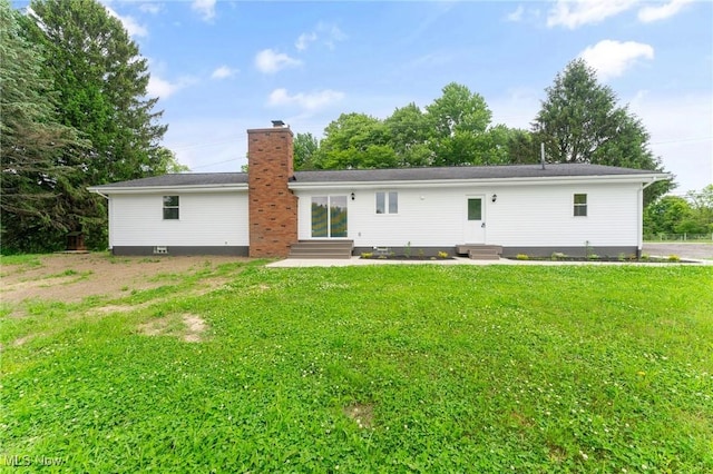 3371 Padanarum Rd, Geneva, OH 44041 - rear view of property featuring entry steps, a chimney, and a lawn