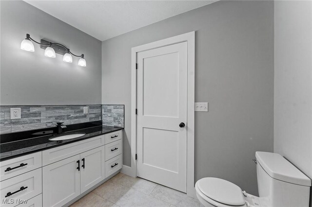 3371 Padanarum Rd, Geneva, OH 44041 - half bath with toilet, tasteful backsplash, vanity, and tile patterned floors