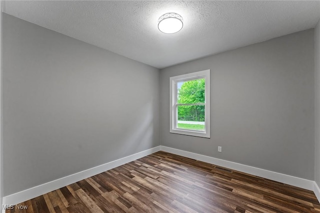 3371 Padanarum Rd, Geneva, OH 44041 - spare room with dark wood-style flooring, baseboards, and a textured ceiling