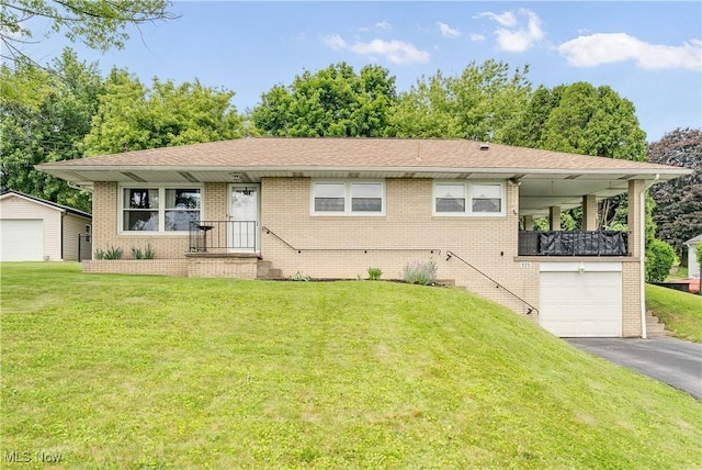 525 Hill Blvd, East Liverpool, OH 43920 - view of front facade featuring brick siding, asphalt driveway, a front lawn, and an attached garage