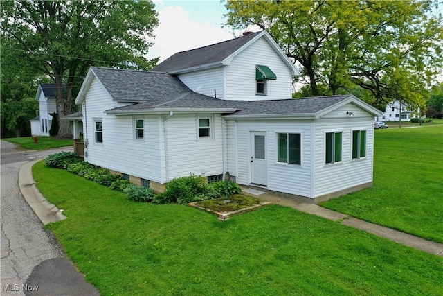 503 S Market St, Shreve, OH 44676 - rear view of property with a lawn and a shingled roof