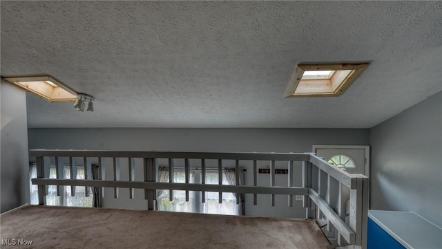 62253 Forestview Dr, Cambridge, OH 43725 - corridor featuring carpet, a textured ceiling, and a skylight