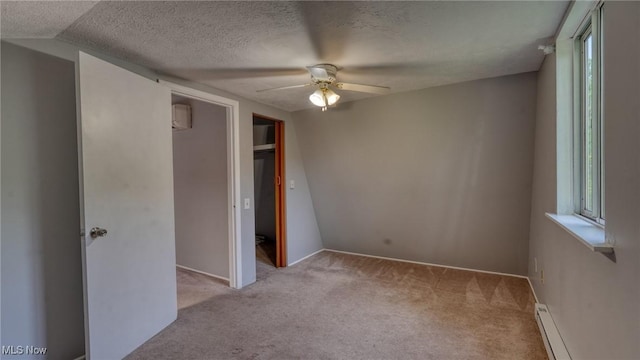 62253 Forestview Dr, Cambridge, OH 43725 - unfurnished bedroom with carpet, multiple windows, baseboard heating, and a textured ceiling