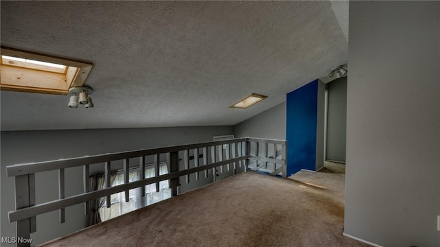 62253 Forestview Dr, Cambridge, OH 43725 - hall with carpet, a textured ceiling, vaulted ceiling, a skylight, and an upstairs landing