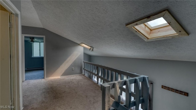 62253 Forestview Dr, Cambridge, OH 43725 - corridor featuring a baseboard radiator, a skylight, carpet flooring, a textured ceiling, and lofted ceiling