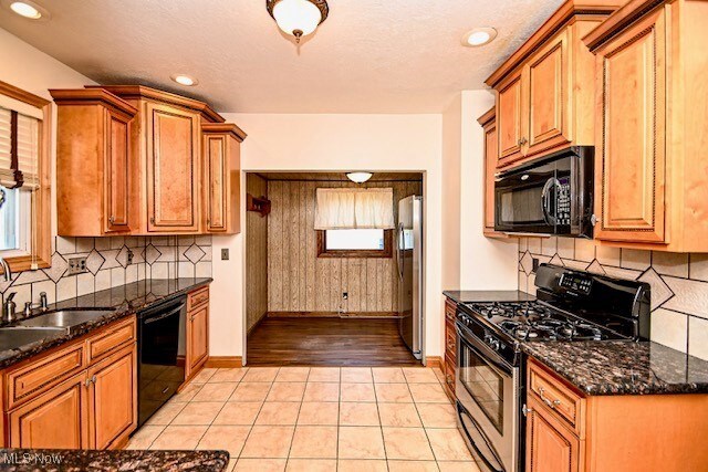 837 Lake Ave NE, Massillon, OH 44646 - kitchen featuring black appliances, baseboards, decorative backsplash, brown cabinets, and recessed lighting