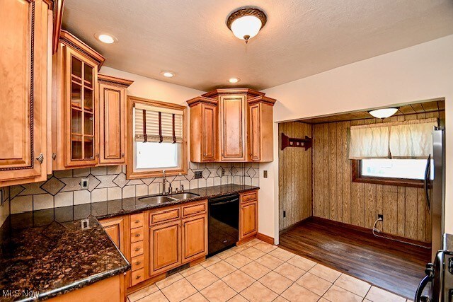 837 Lake Ave NE, Massillon, OH 44646 - kitchen with black dishwasher, plenty of natural light, light tile patterned flooring, and a sink