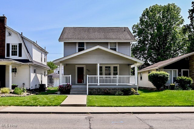837 Lake Ave NE, Massillon, OH 44646 - view of front of house with covered porch and a front yard