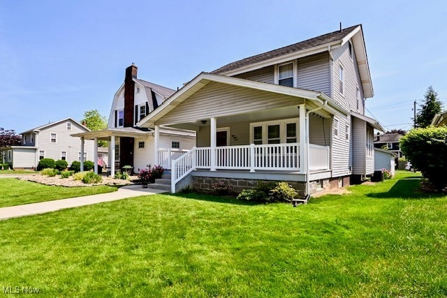 837 Lake Ave NE, Massillon, OH 44646 - view of front of home featuring covered porch, a front lawn, and a chimney