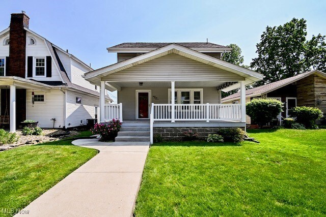 837 Lake Ave NE, Massillon, OH 44646 - view of front of home with a porch and a front lawn