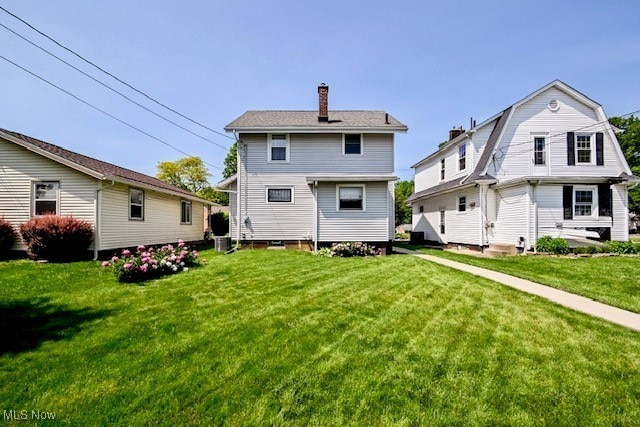 837 Lake Ave NE, Massillon, OH 44646 - rear view of house with a chimney and a yard