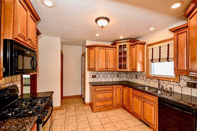 837 Lake Ave NE, Massillon, OH 44646 - kitchen featuring black appliances, a sink, brown cabinetry, tasteful backsplash, and recessed lighting